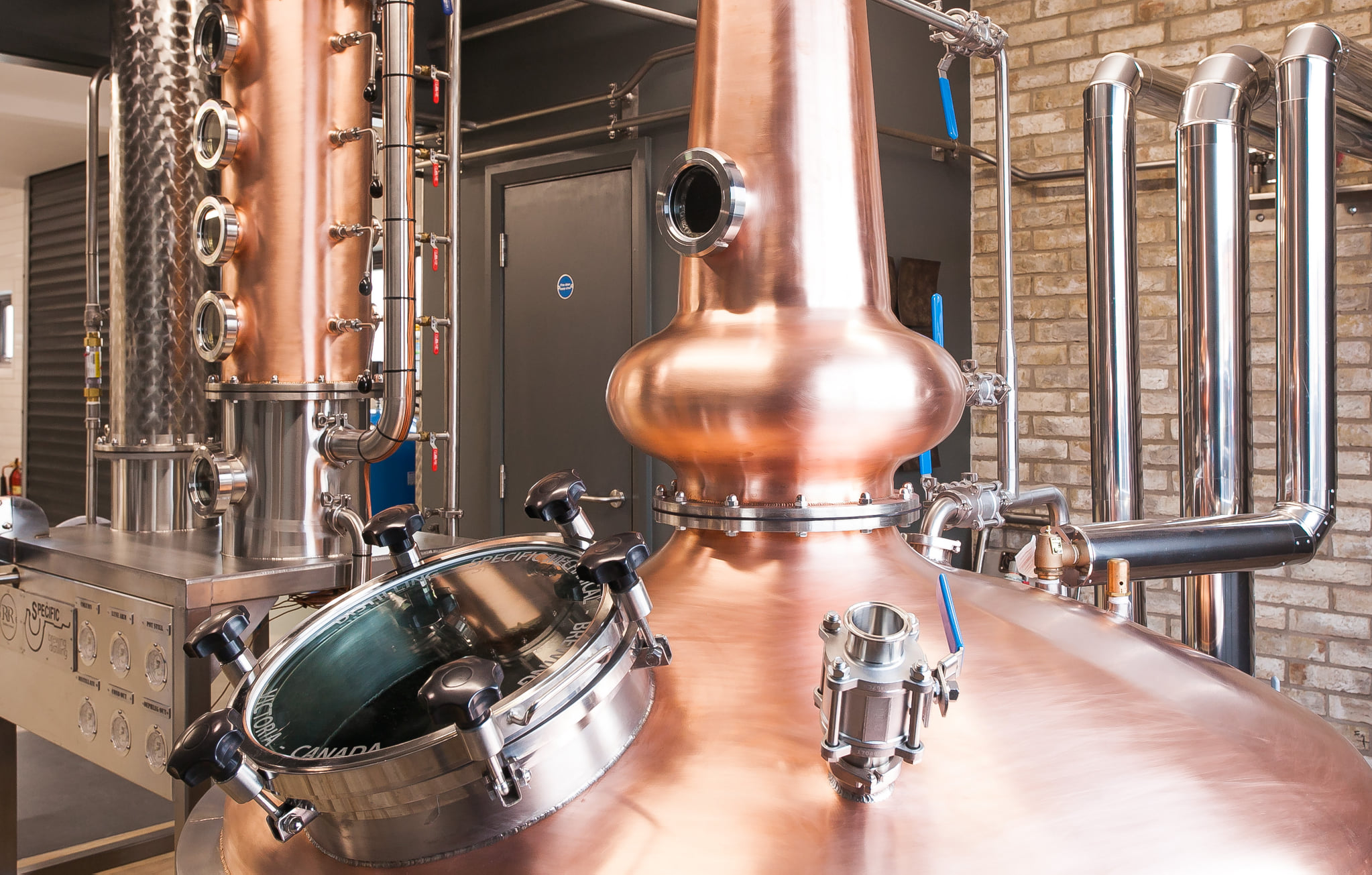 A distilling tank with a copper column in the background.