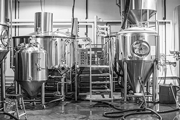 A black and white photograph of the Kansas City Bier Company brewing station all set up.