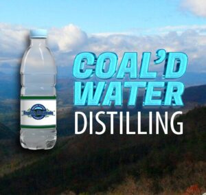 A bottle of water with Coal'D Water Distilling logo.