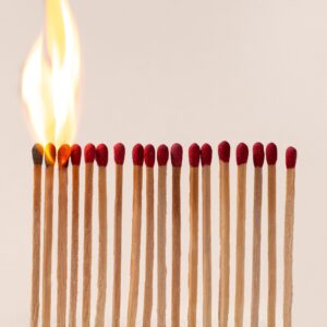 A row of matches and the first four are lit with fire.