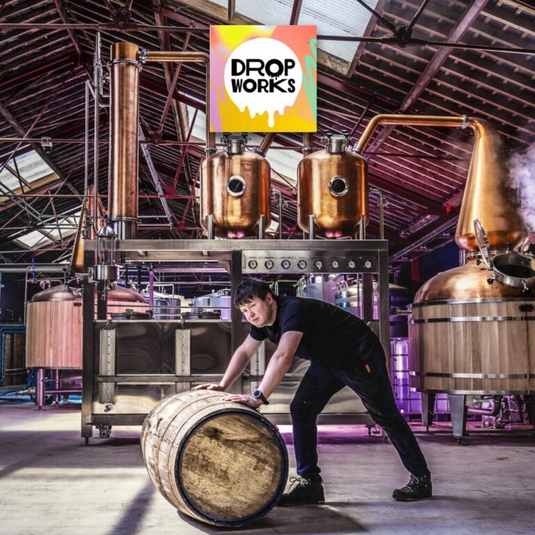 Drop Works Rum Distillery logo and a man pushing a brown barrel.